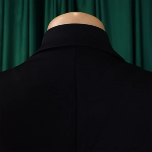 Detail view showing the neckline and shoulder stitching of a black sleeveless jumpsuit