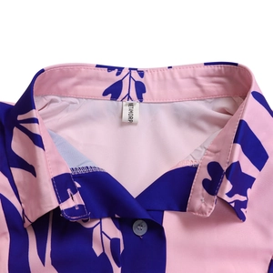 Detail shot of the turnover collar and floral print on a light pink summer dress