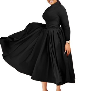 Detail of high neck black pleated dress with long sleeves and flowing wide hem skirt