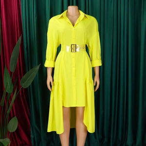Detail of yellow shirt dress featuring asymmetrical hem and transparent PVC belt