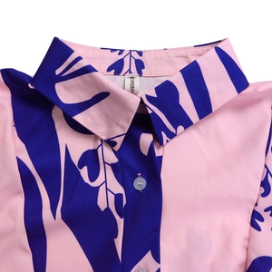 Detail of shirt collar with pink and blue floral print and white button closure