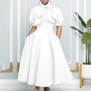 Close-up of elegant bow tie collar and puff sleeves on white A-line party dress