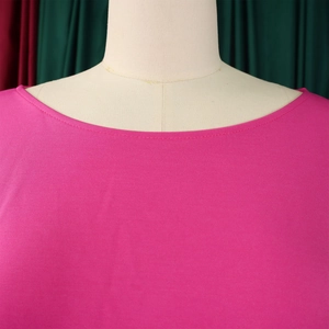 Detail of boat neck neckline on rose pink jumpsuit with double-needle stitching quality