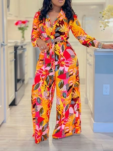 Two-piece tropical floral print set with a tie-front crop shirt and wide-leg trousers