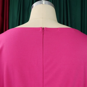 Detail view of pink wide-leg jumpsuit showing back neckline and invisible zipper closure
