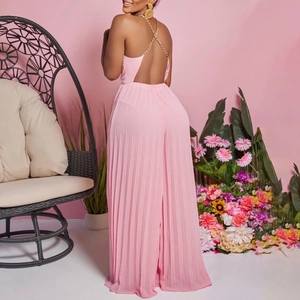 Detailed back view of pink pleated wide-leg jumpsuit with metal chain neck strap