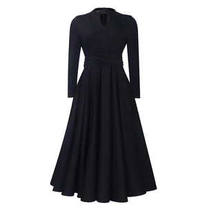 Detail of elegant black long-sleeve dress with cutout neckline and pleated waist design