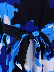 Detailed macro view of the waist area on a camo print dress with a black bow ribbon belt