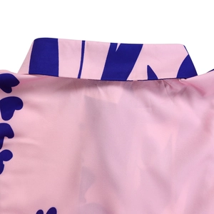 Close-up of pink dress lapel collar featuring navy blue abstract print patterns