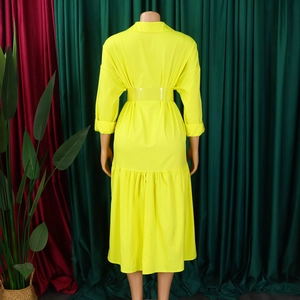 Back view of yellow long sleeve shirt dress with cinched waist and ruffle hem detail