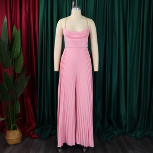 Detail of pink pleated wide-leg jumpsuit with elegant golden chain halter neck strap