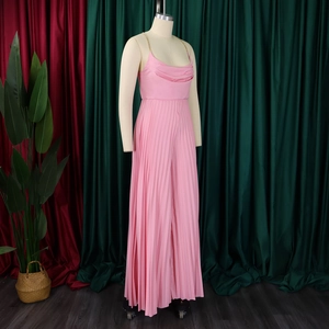 Pink pleated wide-leg jumpsuit featuring metallic chain straps and elegant cowl neckline