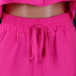 Detail of rose red high-waisted elastic waistband with matching drawstring on shorts