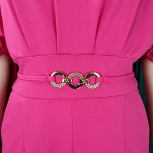 Detail of high waist rose red jumpsuit with gold rhinestone buckles and fabric texture
