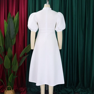 Back view of a white puff sleeve cocktail dress with a zipper and A-line silhouette