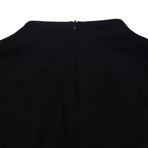 Detail view of the hidden zipper design and smooth black knit fabric on the maxi dress