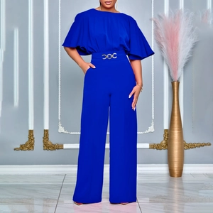 Detail of bright blue wide-leg jumpsuit with elegant cape sleeves and gold belt buckle