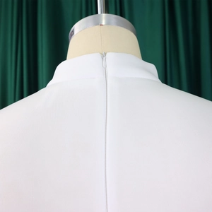 Close-up of invisible zipper closure on back of white short-sleeve summer banquet dress