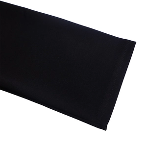 Close-up of black dress hem showing professional double-stitching and fabric texture