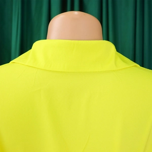 Detail view of the fluorescent yellow lapel collar and shoulder stitching on casual shirt dress