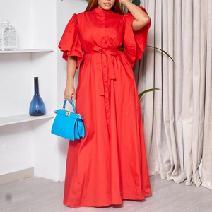 Detail of red long dress showing button-front closure, waist tie and dramatic flare sleeves