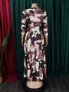Back view of a long-sleeve camouflage maxi dress with waist tie and concealed zipper