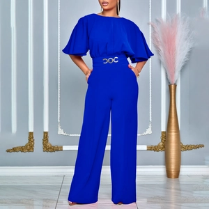 Close-up of royal blue wide-leg jumpsuit with gold buckle belt and elegant ruffled sleeves