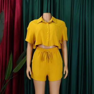 Close-up of yellow textured fabric on two-piece short sleeve shirt and shorts set