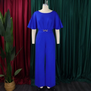 Detail of royal blue jumpsuit showing flutter sleeves and gold chain waist buckle