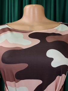Detailed view of the pink and brown camo print fabric and soft draped neckline of this dress