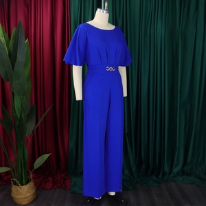 Detail of blue wide-leg jumpsuit featuring elegant ruffled sleeves and a gold waist buckle