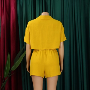 Rear view of ginger yellow textured two-piece short set with elastic waist shorts on a mannequin
