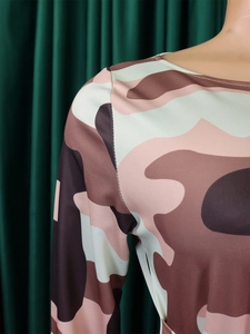 Detail of pink camo print knit fabric and neckline stitching on African style midi dress