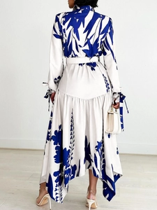 Plus size long sleeve dress with blue floral print and asymmetric hem with waist belt