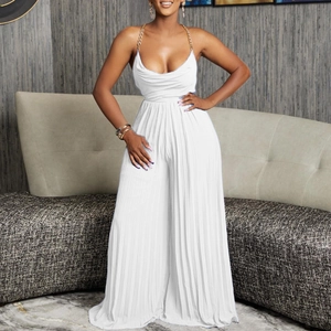 Close-up of pleated white wide-leg jumpsuit featuring elegant gold chain neck straps
