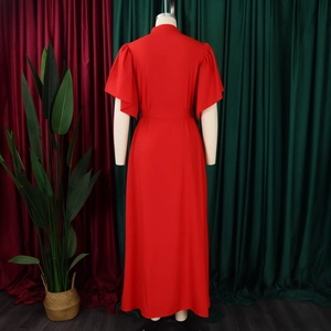 Detail view of red flared sleeve dress back showing high waist cut on a mannequin