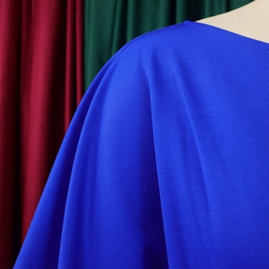 Detail of royal blue jumpsuit showing high-quality textured fabric on shoulder and neckline