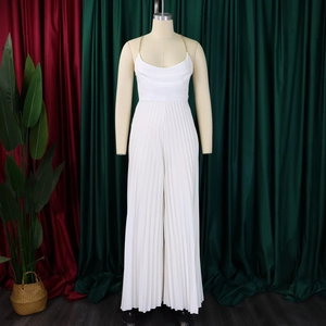 Detail of white pleated jumpsuit with chain straps and cowl neck on mannequin
