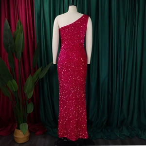 Detail of magenta sequins on a one-shoulder formal evening gown with high side slit