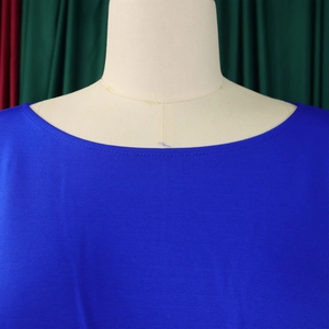 Detailed view of the dark blue wide-leg jumpsuit neckline and premium woven fabric texture