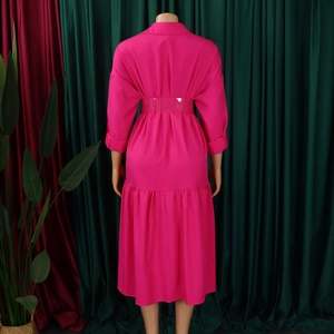 Rear view of fuchsia button-up midi dress featuring waist belt and pleated back detail