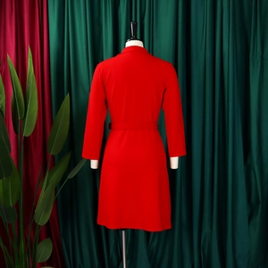 Detail of red high-waist pleated blazer dress showing tailored back and waist belt