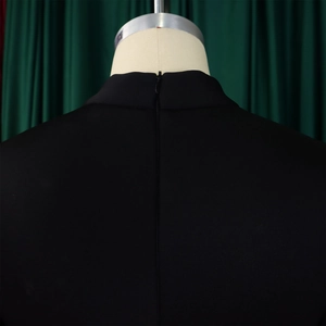 Detail view of high neckline and hidden back zipper on elegant black evening dress