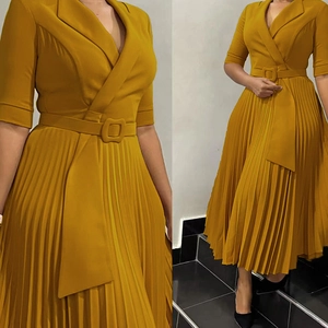 Détail de jupe plissée et taille ceinturée sur robe blazer jaune moutarde à col V