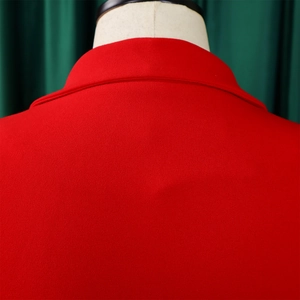 Close-up of red pleated dress collar and upper back stitching on white mannequin