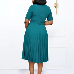 Detailed back view of a dark green pleated midi dress with short sleeves and waist belt