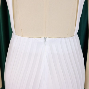 Macro detail of high waist pleats and invisible zipper on white wide leg jumpsuit