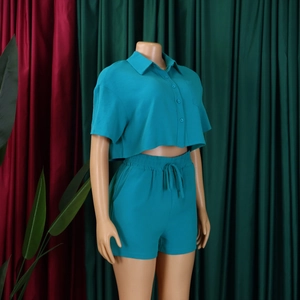 Detail of teal women summer set showing lapel short sleeve crop top and drawstring shorts