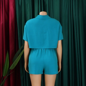 Rear view detail of teal crop top and high-waisted shorts set on a display mannequin