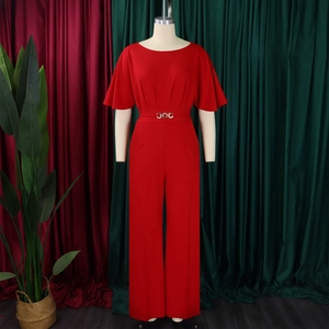 Detail of red wide-leg jumpsuit with golden waist buckle and ruffle sleeves
